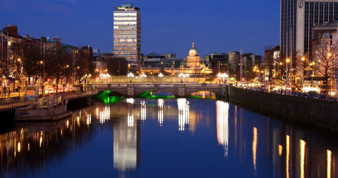 Dublin city at sunset with view over O'Connell Bridge and Liffey river.