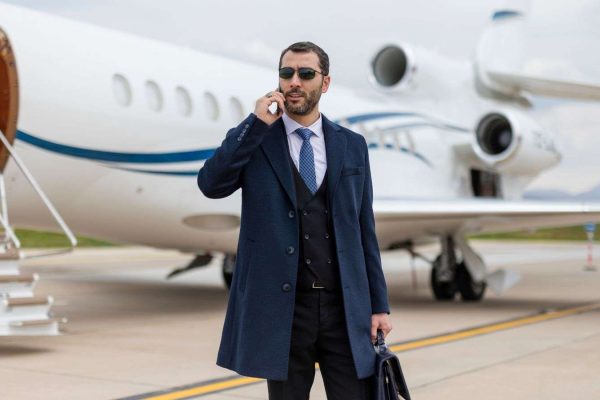 Premier Chauffeur Drive's Corporate Client standing in front of a private jet using their Dublin chauffeur services