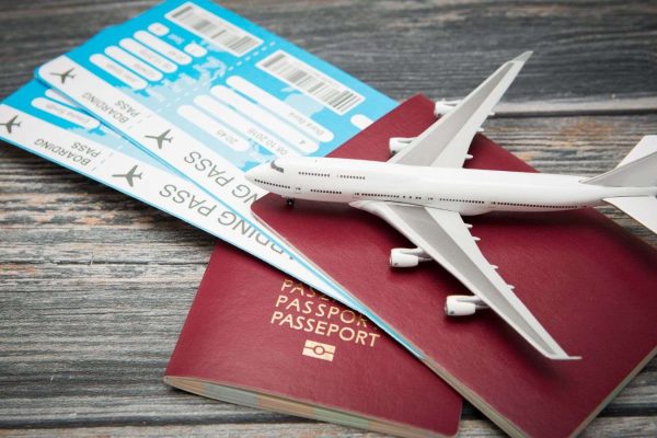 A model aeroplane on top of two tickets and passports for Premier Chauffeur Drive's Private Airport Transfer Service